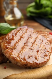 Photo of Delicious hamburger patties and spices on table, closeup