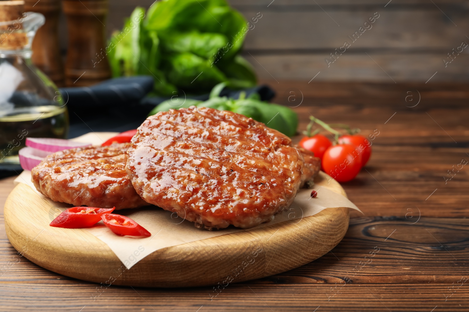 Delicious hamburger patties and spices on wooden table, closeup. Space for text Photo of Delicious hamburger patties and spices on wooden table, closeup. Space for text