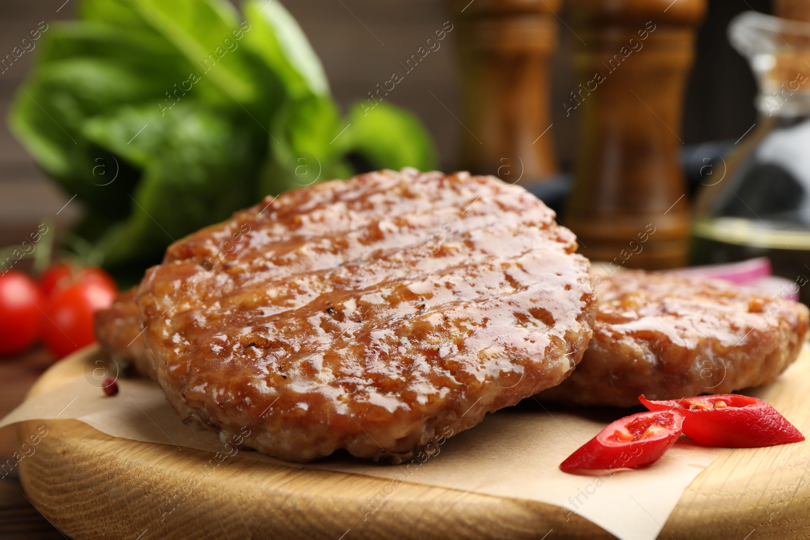 Delicious hamburger patties and spices on table, closeup Photo of Delicious hamburger patties and spices on table, closeup