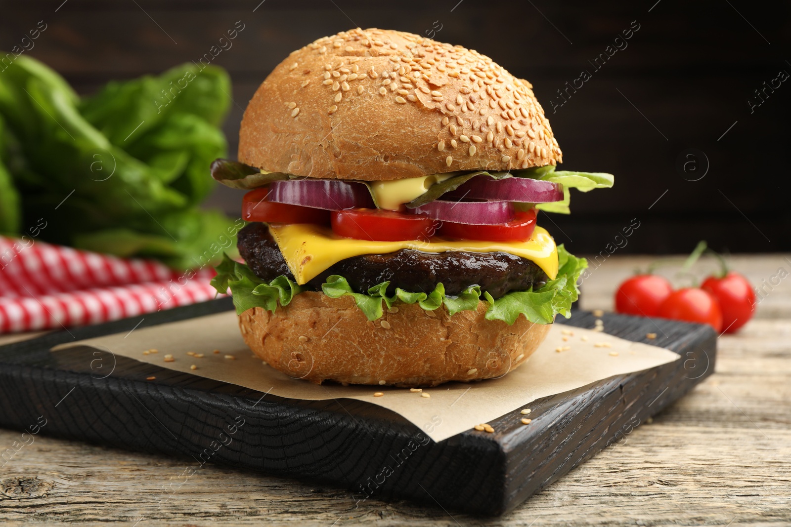 Delicious hamburger with patty and cheese on wooden table, closeup Photo of Delicious hamburger with patty and cheese on wooden table, closeup