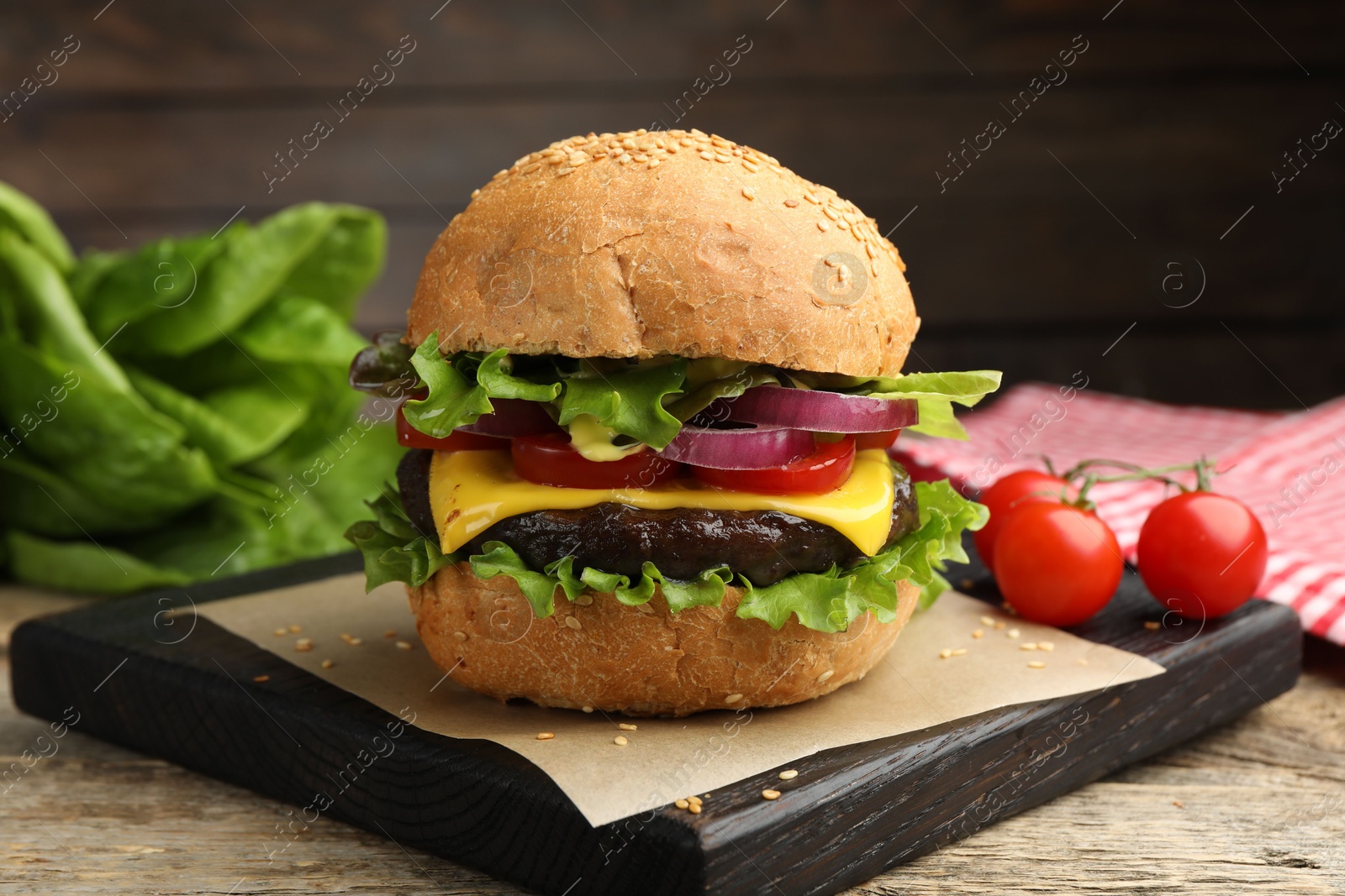 Delicious hamburger with patty and cheese on wooden table, closeup Photo of Delicious hamburger with patty and cheese on wooden table, closeup