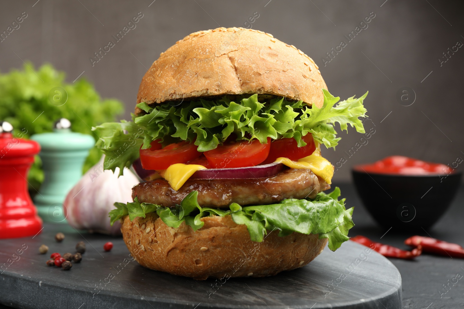Delicious hamburger with patty served on black table, closeup Photo of Delicious hamburger with patty served on black table, closeup