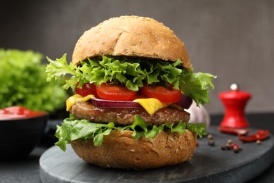 Photo of Delicious hamburger with patty served on table, closeup