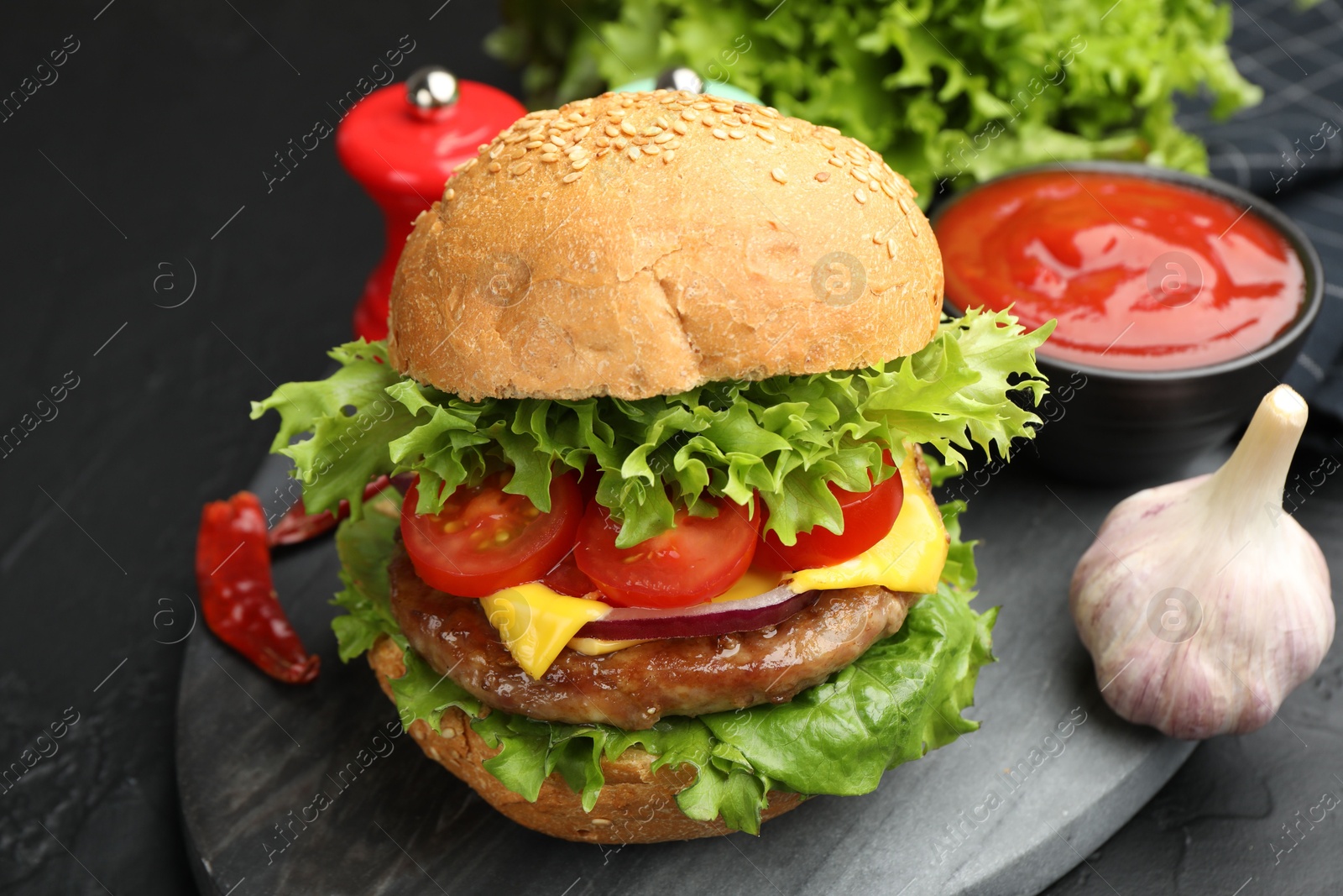 Delicious hamburger with patty served on black table, closeup Photo of Delicious hamburger with patty served on black table, closeup