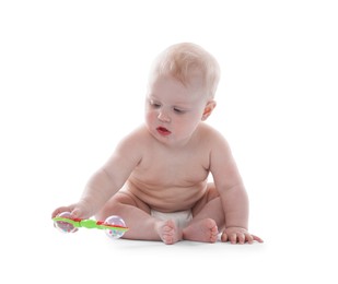 Photo of Cute little baby with rattle on white background