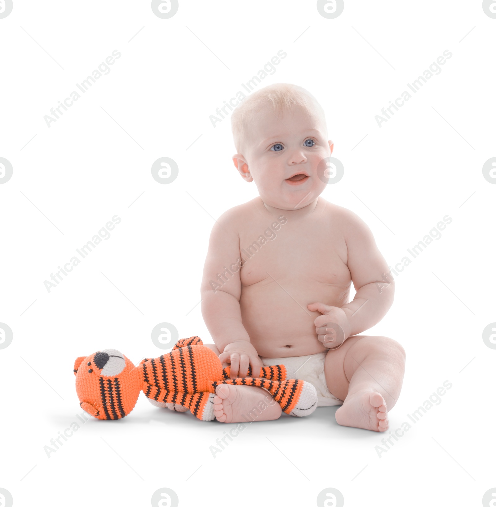 Cute little baby with knitted toy tiger on white background Photo of Cute little baby with knitted toy tiger on white background