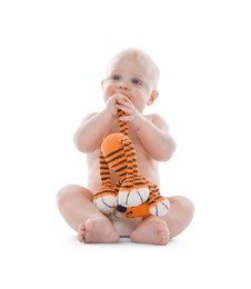 Photo of Cute little baby with knitted toy tiger on white background