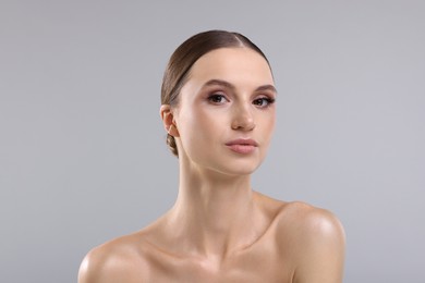 Photo of Portrait of beautiful young woman on gray background