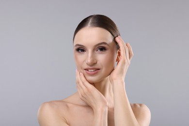 Photo of Portrait of beautiful young woman on gray background