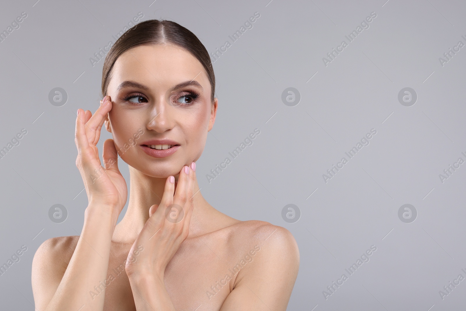 Photo of Portrait of beautiful young woman on gray background, space for text