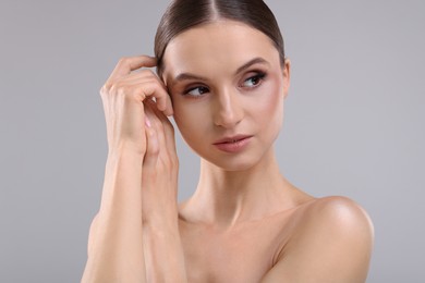 Photo of Portrait of beautiful young woman on gray background