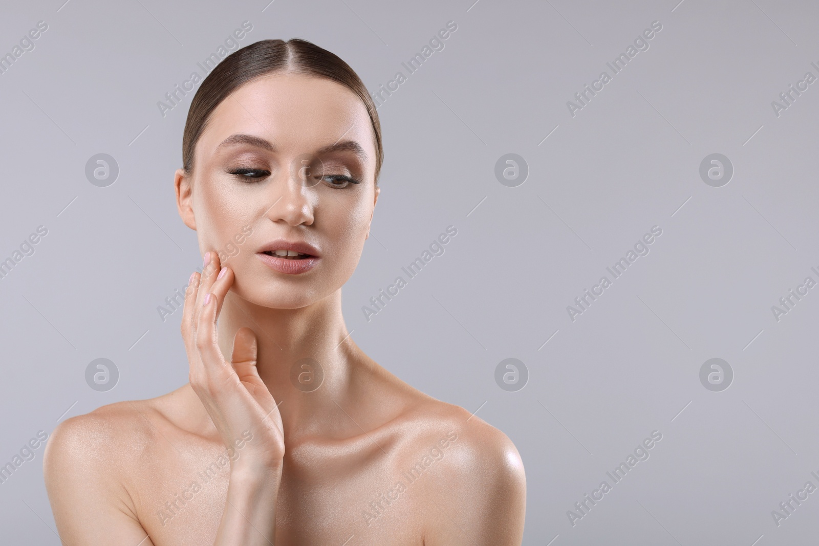 Photo of Portrait of beautiful young woman on gray background, space for text