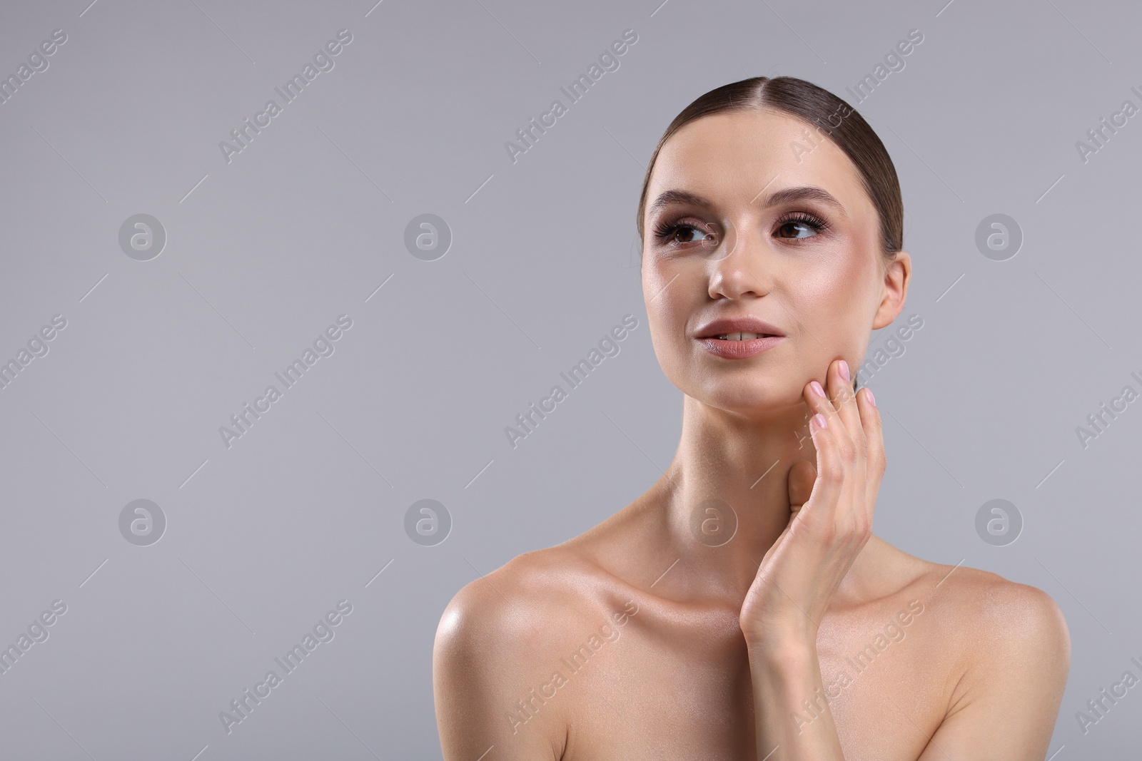 Photo of Portrait of beautiful young woman on gray background, space for text