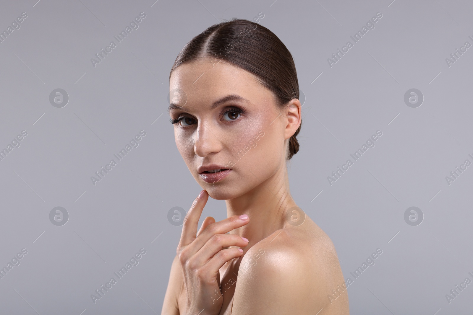 Portrait of beautiful young woman on gray background Photo of Portrait of beautiful young woman on gray background