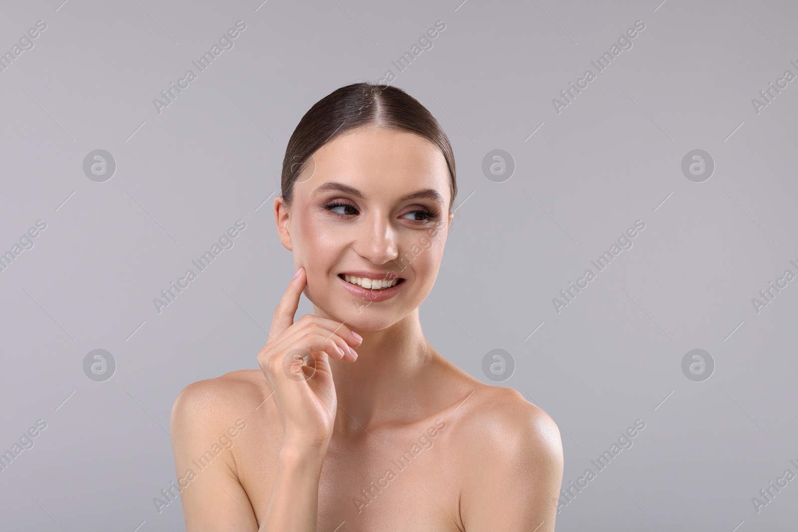 Portrait of beautiful young woman on gray background Photo of Portrait of beautiful young woman on gray background