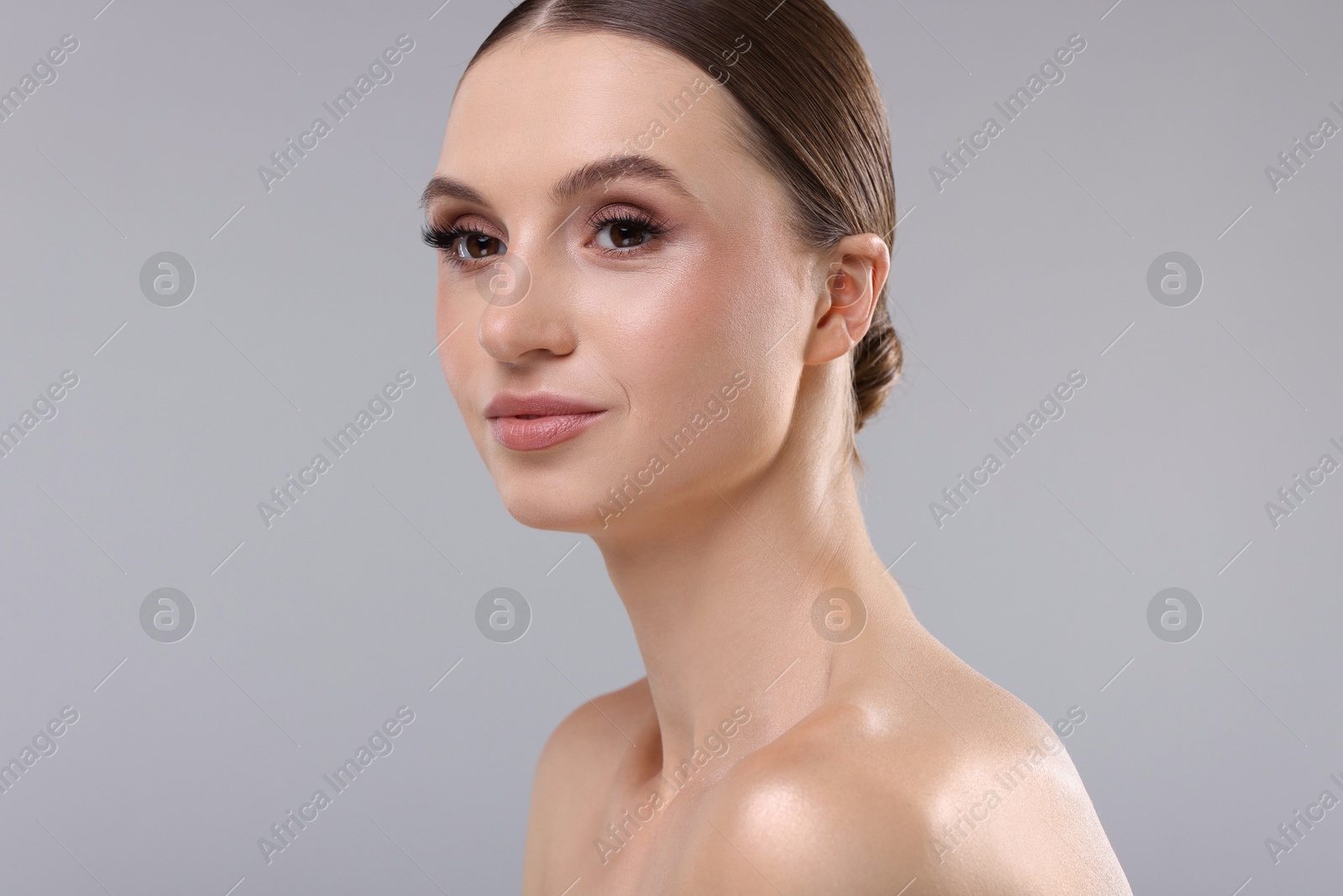 Photo of Portrait of beautiful young woman on gray background