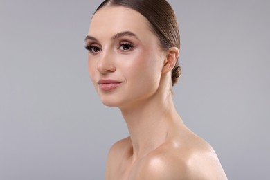 Photo of Portrait of beautiful young woman on gray background