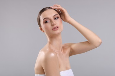 Photo of Portrait of beautiful young woman on gray background