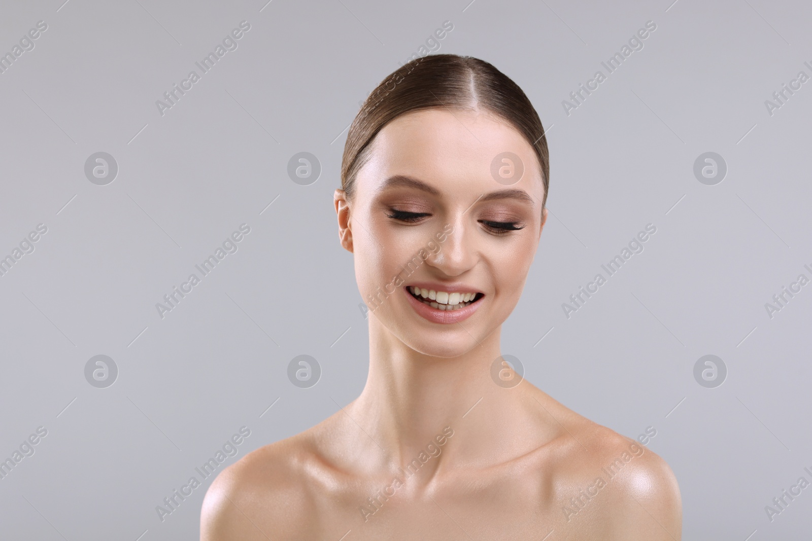 Portrait of beautiful young woman on gray background Photo of Portrait of beautiful young woman on gray background
