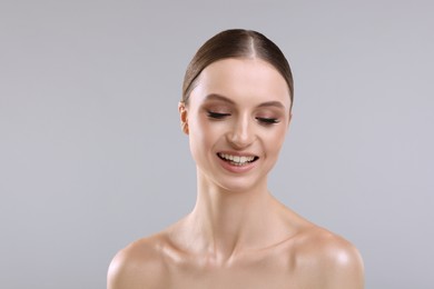 Photo of Portrait of beautiful young woman on gray background