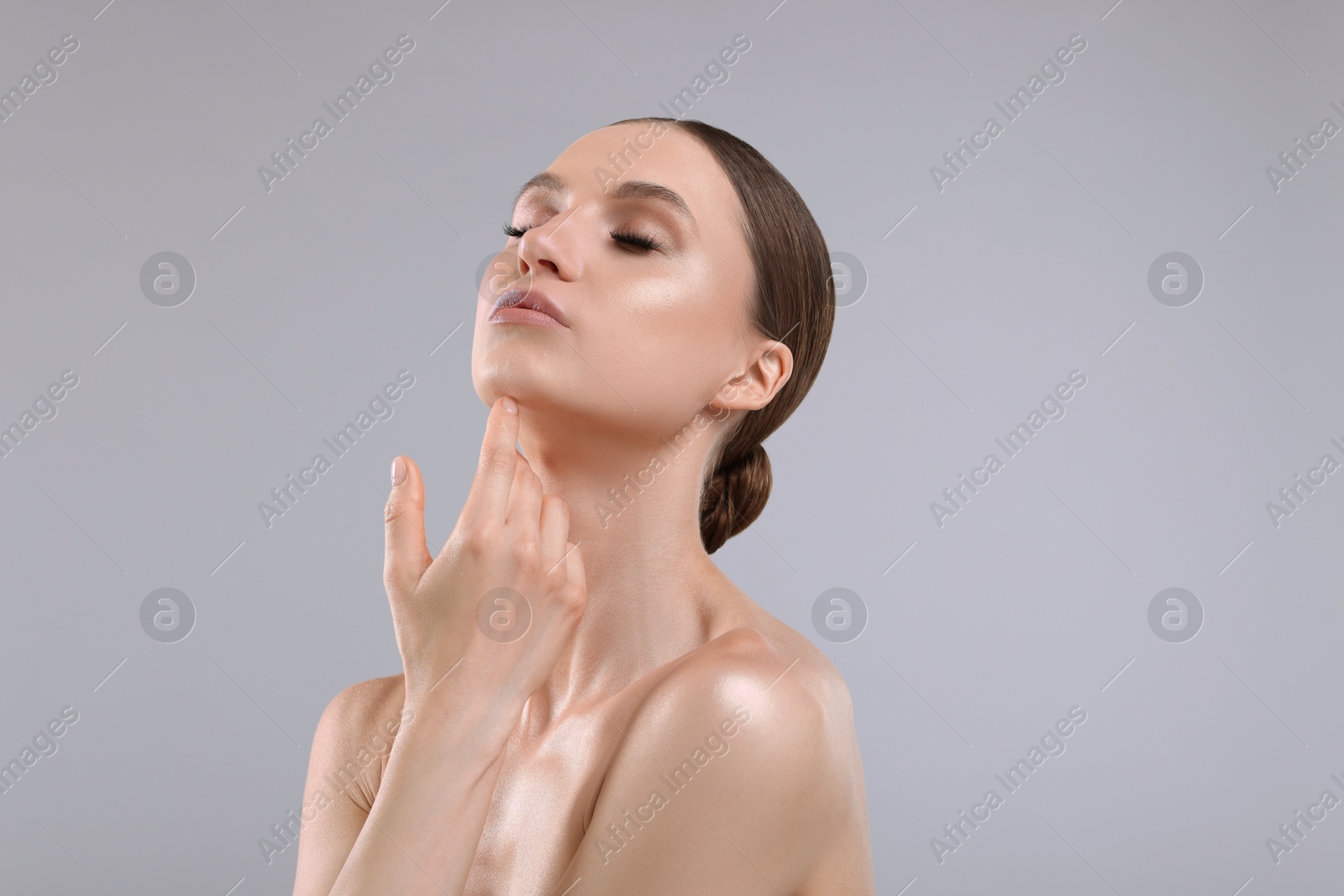 Portrait of beautiful young woman on gray background Photo of Portrait of beautiful young woman on gray background
