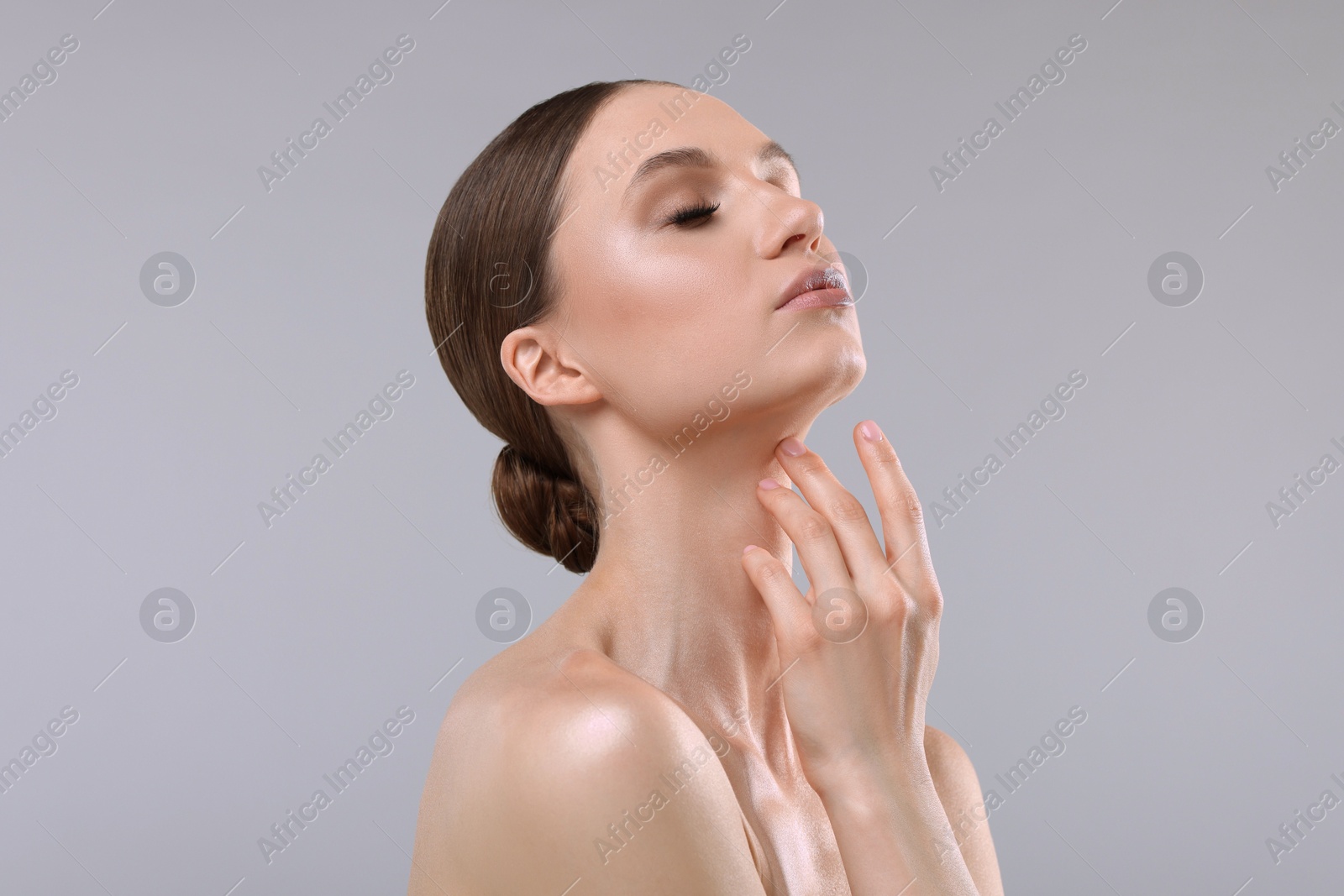 Portrait of beautiful young woman on gray background Photo of Portrait of beautiful young woman on gray background