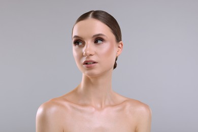 Photo of Portrait of beautiful young woman on gray background