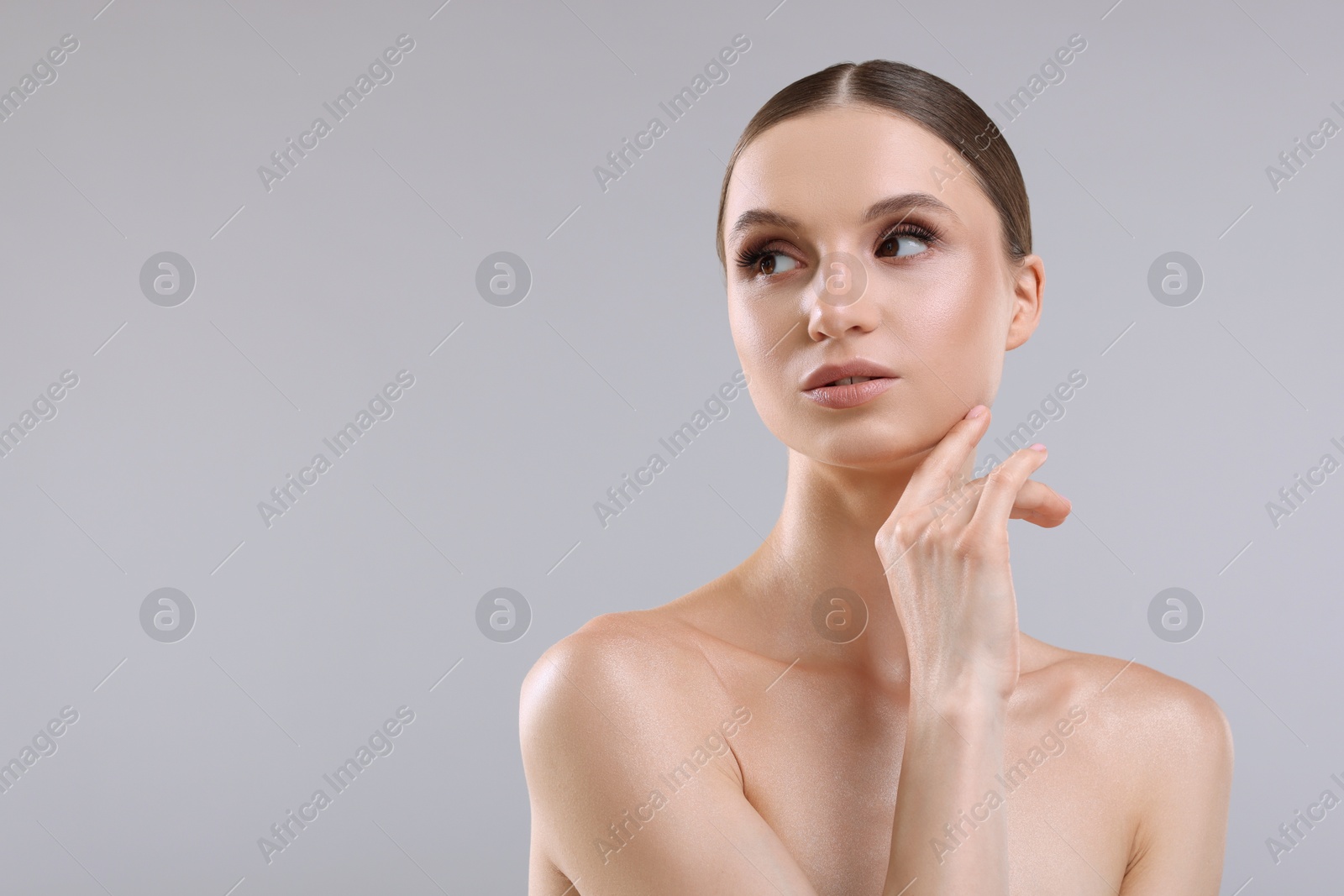 Photo of Portrait of beautiful young woman on gray background, space for text