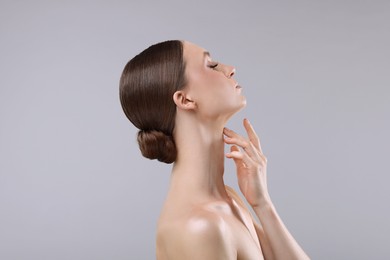 Photo of Portrait of beautiful young woman on gray background