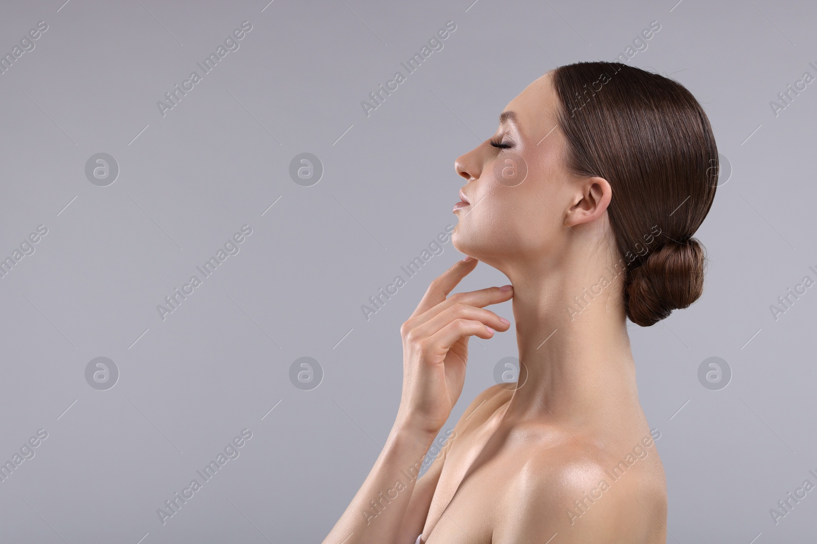 Photo of Portrait of beautiful young woman on gray background, space for text