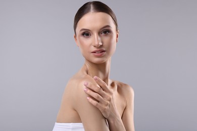 Photo of Portrait of beautiful young woman on gray background