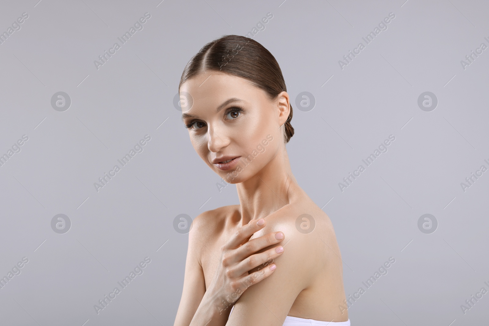 Portrait of beautiful young woman on gray background Photo of Portrait of beautiful young woman on gray background
