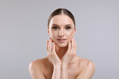 Photo of Portrait of beautiful young woman on gray background