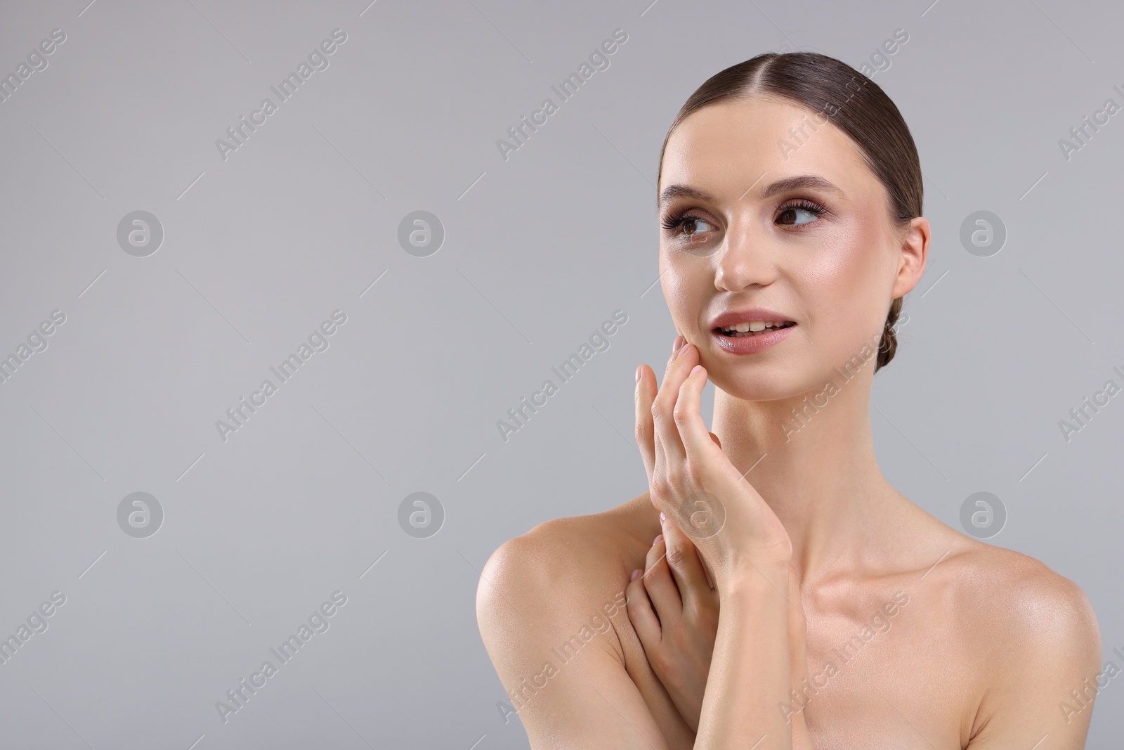 Photo of Portrait of beautiful young woman on gray background, space for text