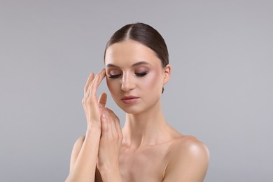 Photo of Portrait of beautiful young woman on gray background