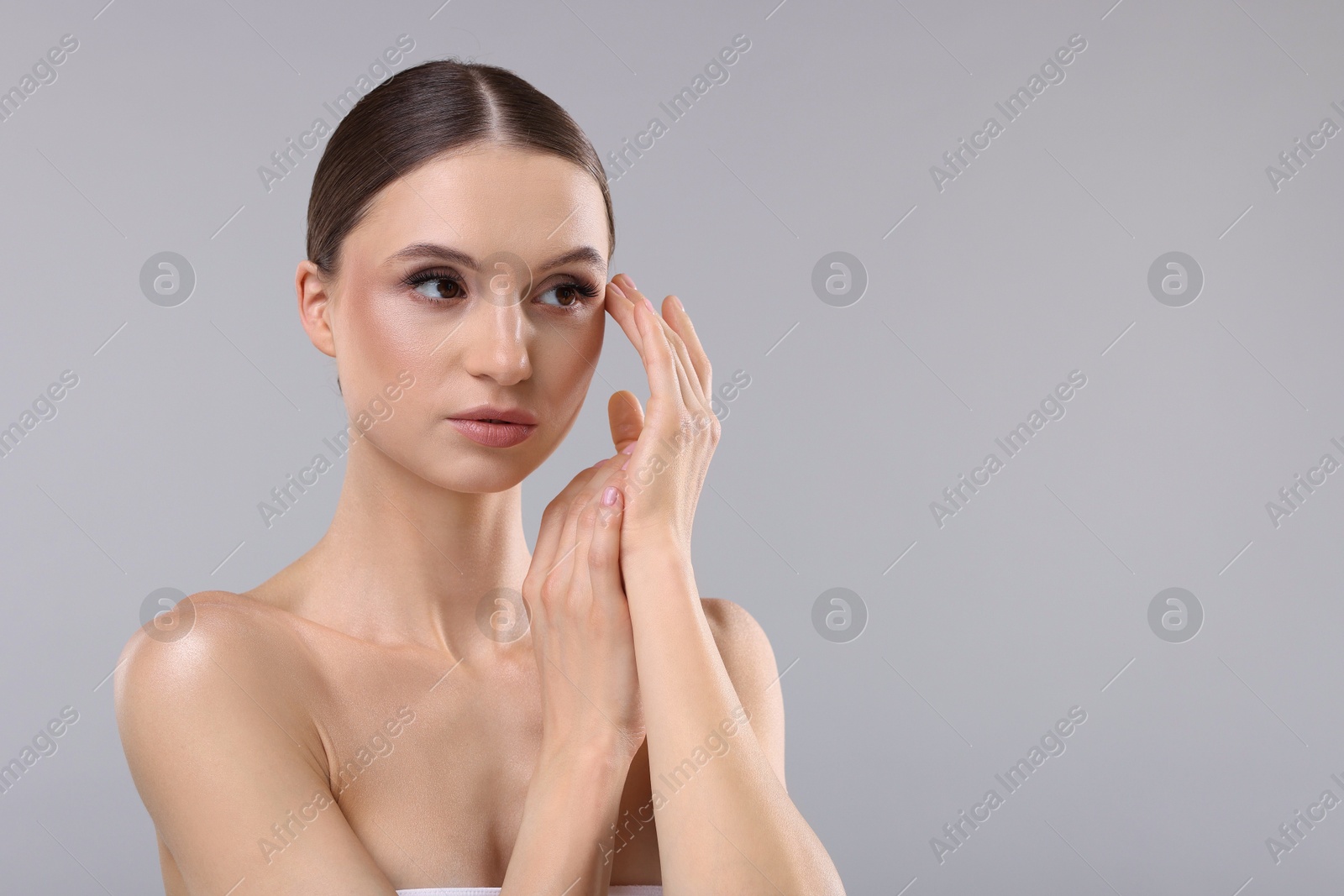 Portrait of beautiful young woman on gray background, space for text Photo of Portrait of beautiful young woman on gray background, space for text