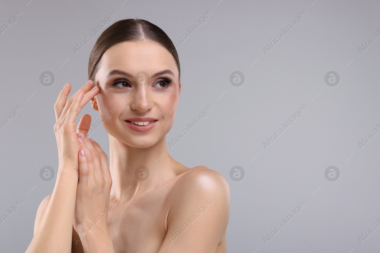 Photo of Portrait of beautiful young woman on gray background, space for text