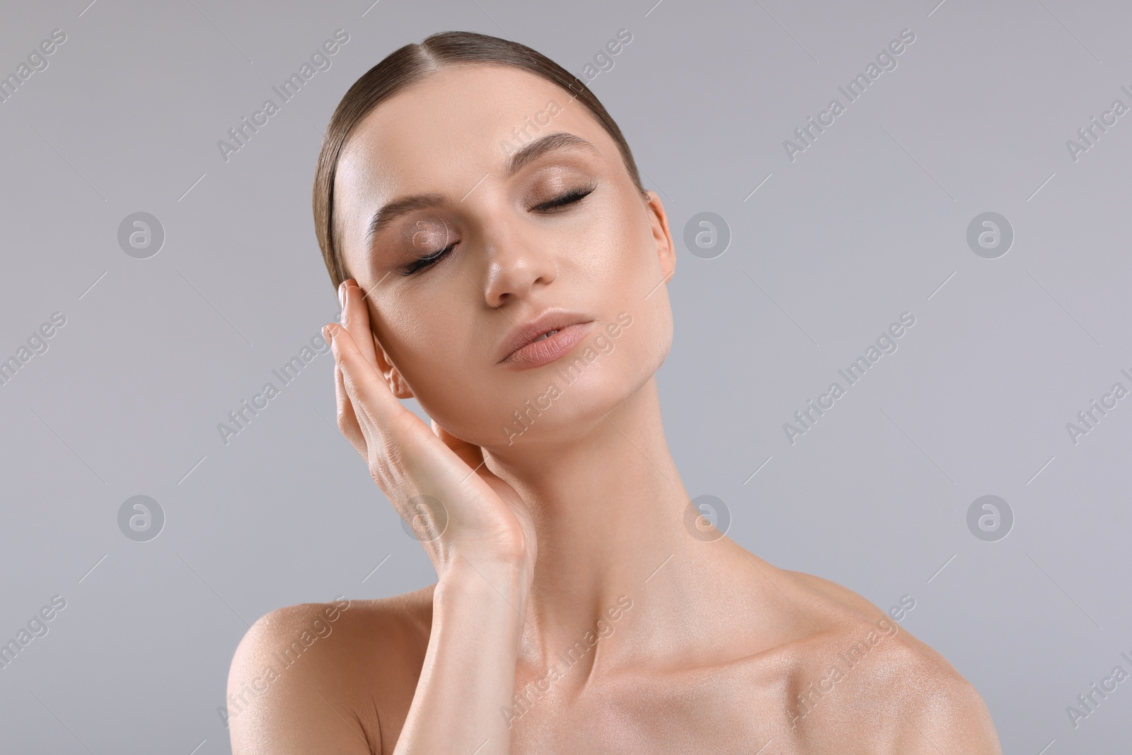 Portrait of beautiful young woman on gray background Photo of Portrait of beautiful young woman on gray background