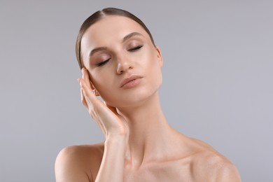 Photo of Portrait of beautiful young woman on gray background