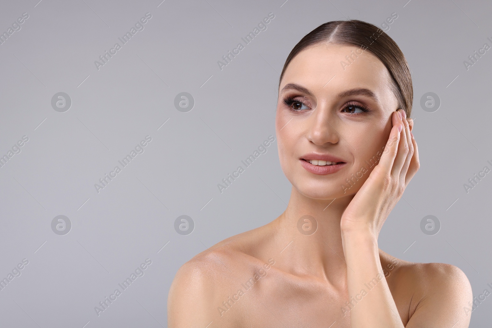 Photo of Portrait of beautiful young woman on gray background, space for text