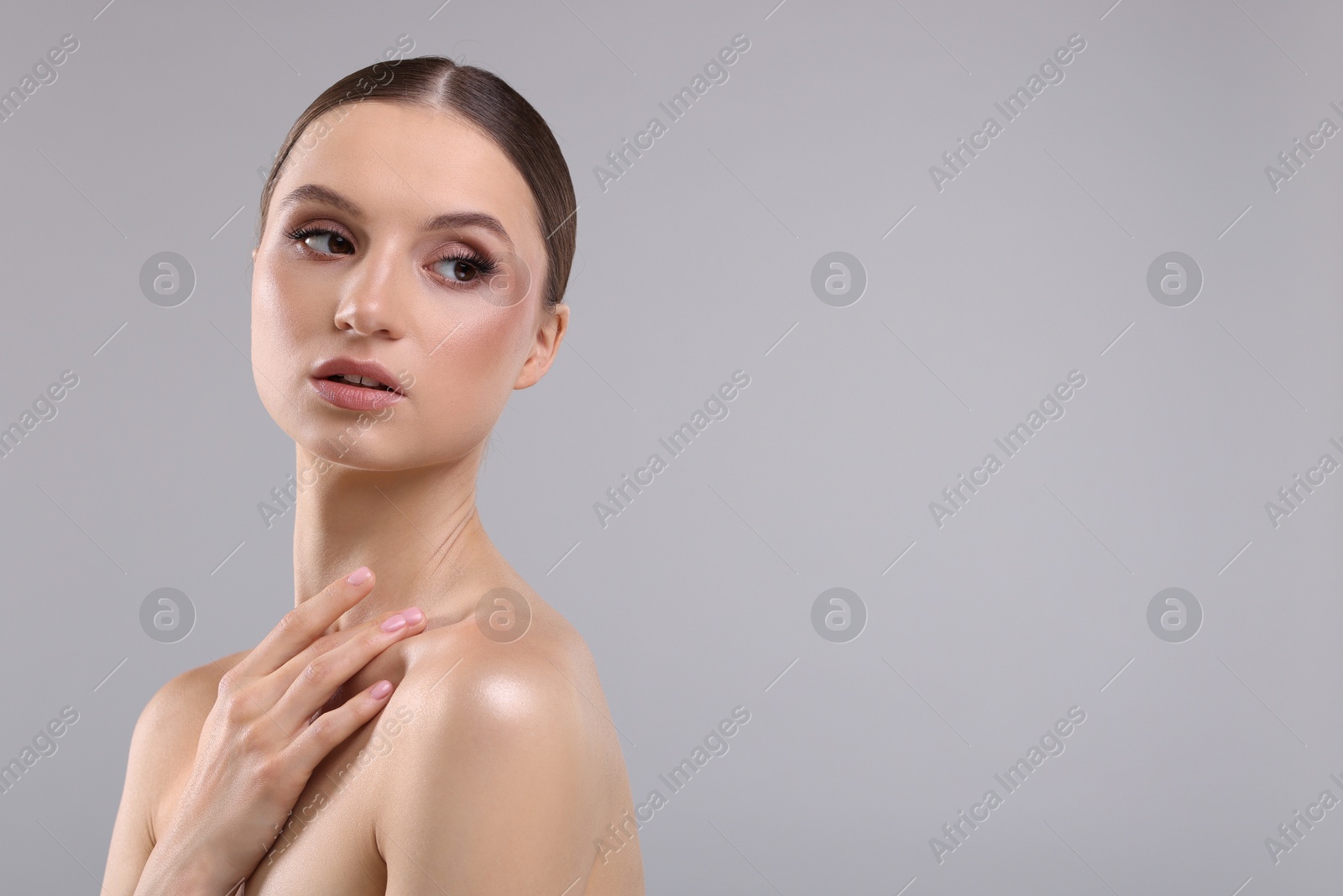 Photo of Portrait of beautiful young woman on gray background, space for text