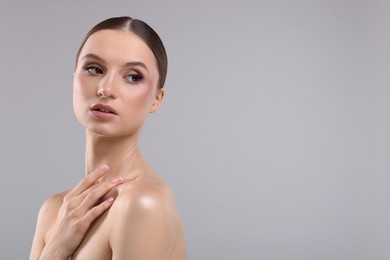 Photo of Portrait of beautiful young woman on gray background, space for text