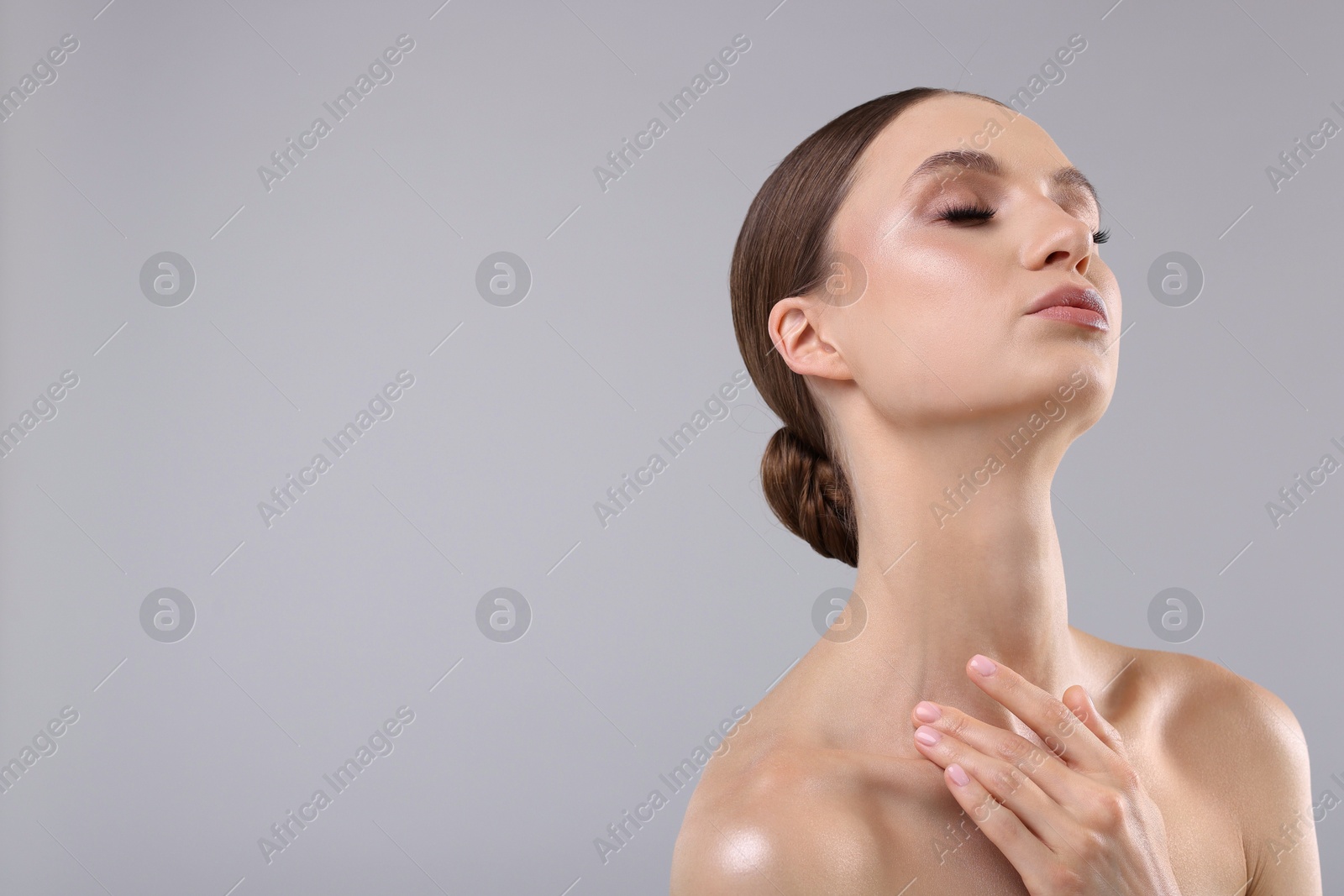 Photo of Portrait of beautiful young woman on gray background, space for text