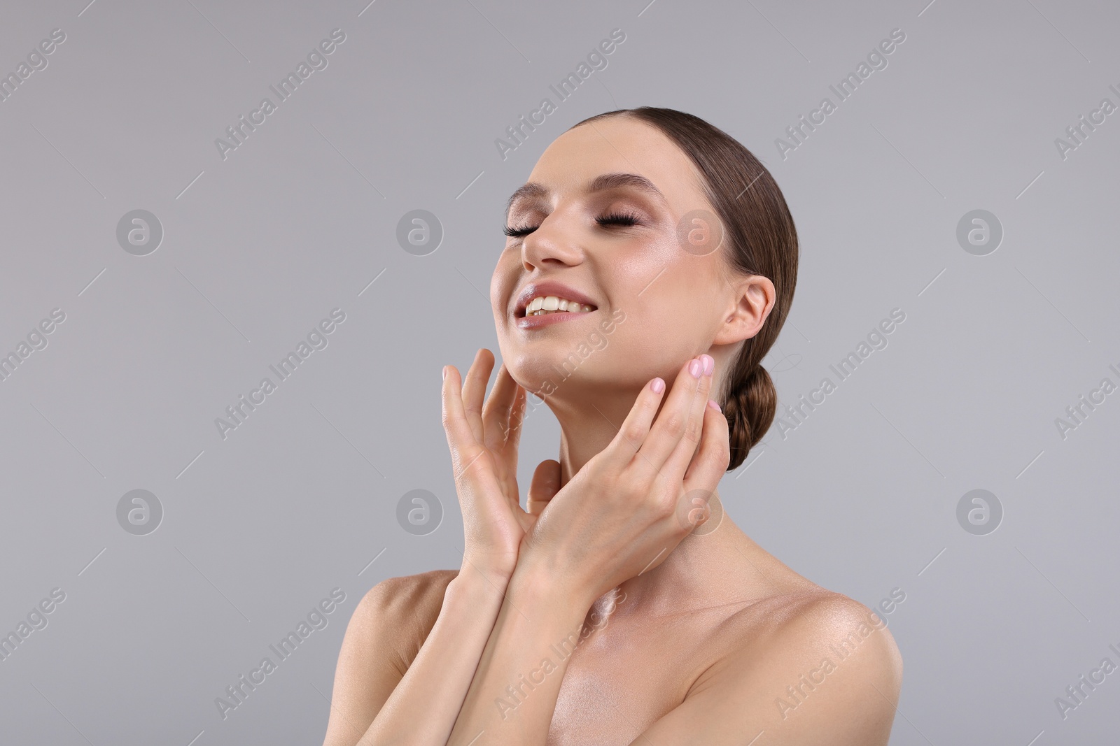 Portrait of beautiful young woman on gray background Photo of Portrait of beautiful young woman on gray background