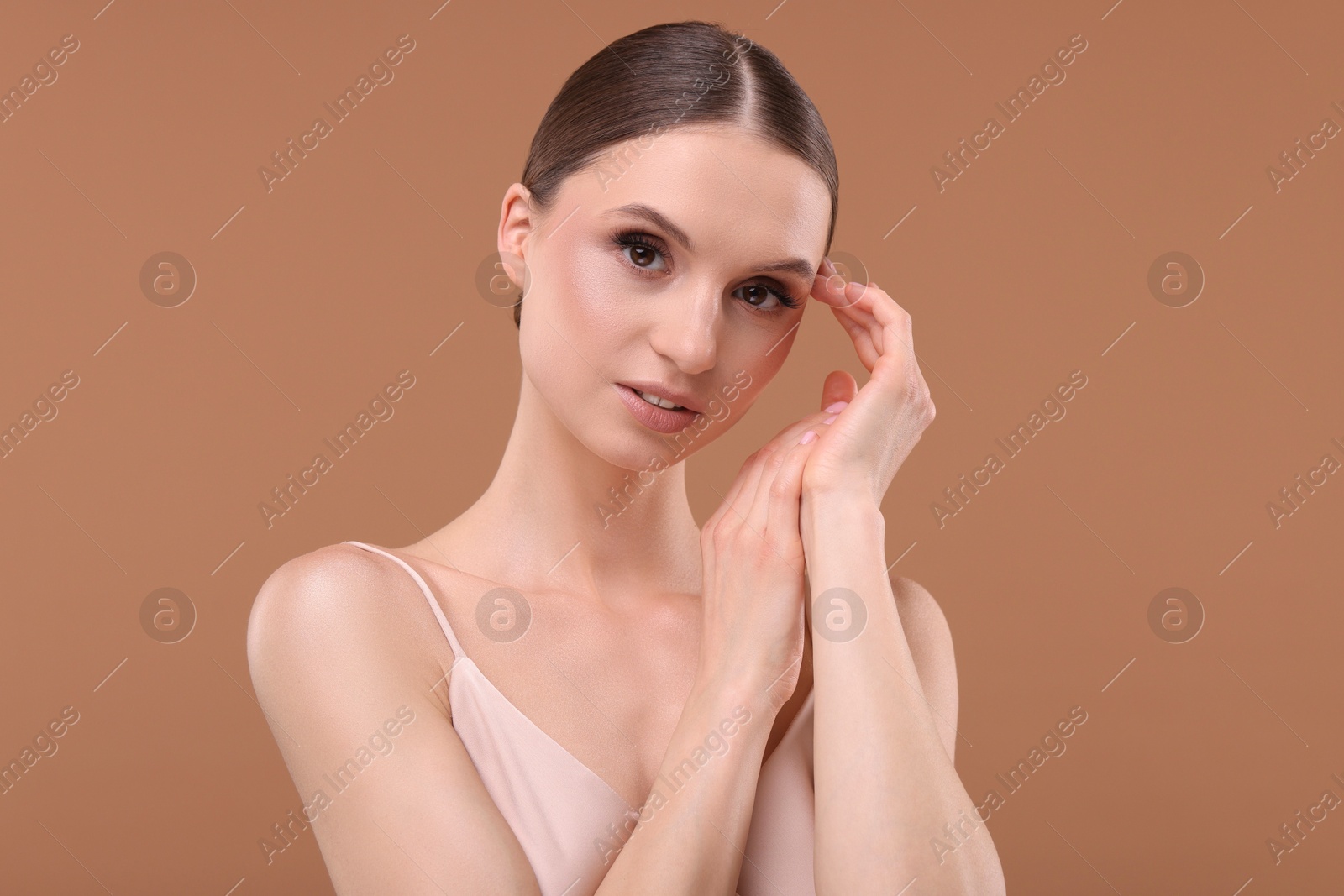 Portrait of beautiful young woman on beige background Photo of Portrait of beautiful young woman on beige background