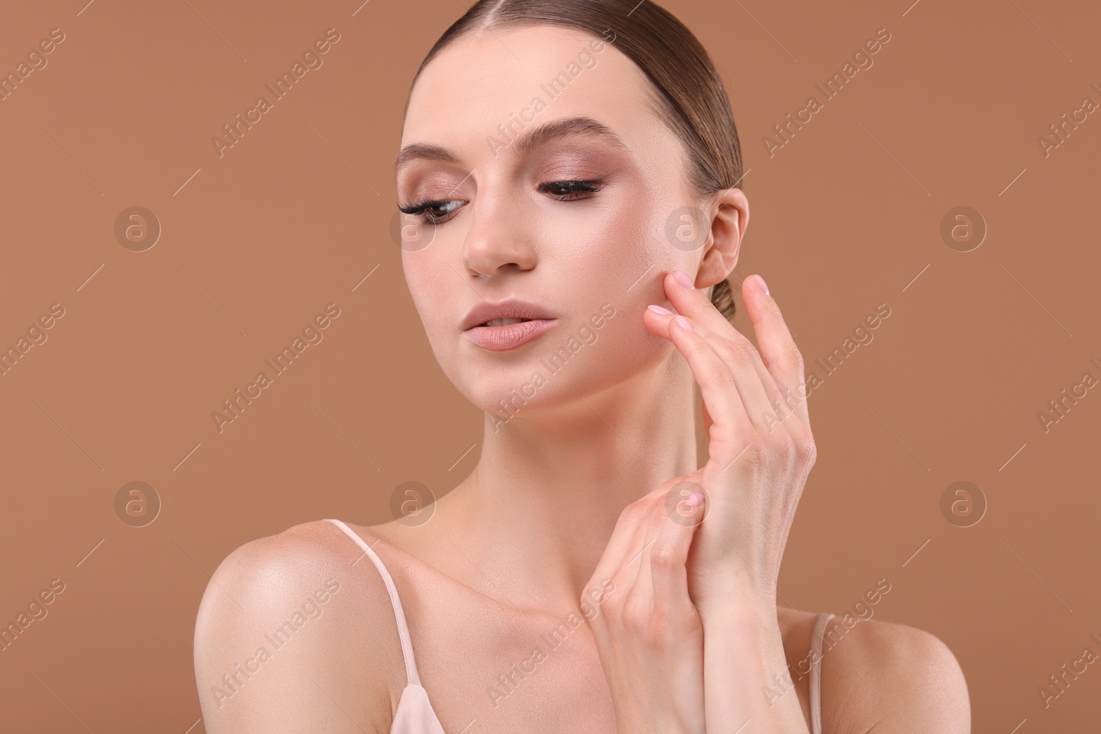 Portrait of beautiful young woman on beige background Photo of Portrait of beautiful young woman on beige background