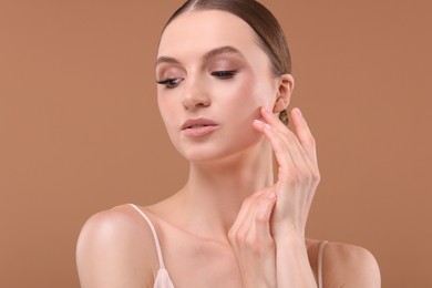 Photo of Portrait of beautiful young woman on beige background