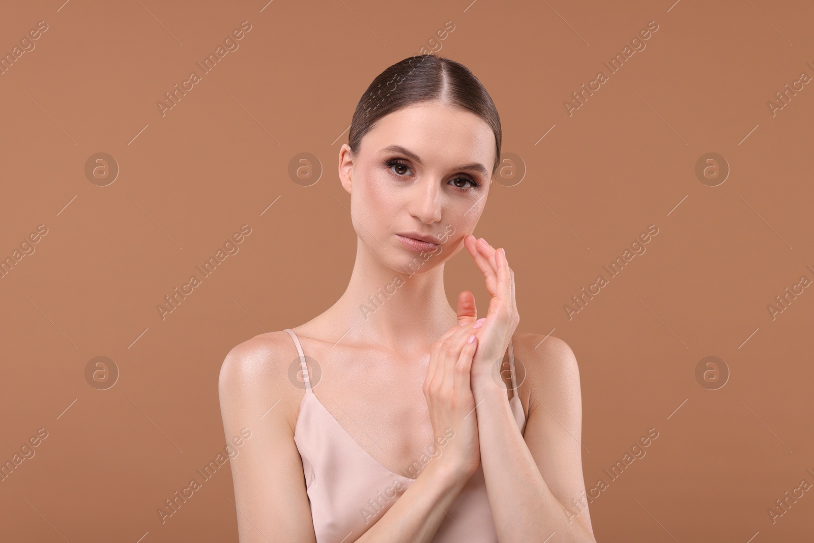 Portrait of beautiful young woman on beige background Photo of Portrait of beautiful young woman on beige background