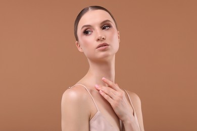 Photo of Portrait of beautiful young woman on beige background