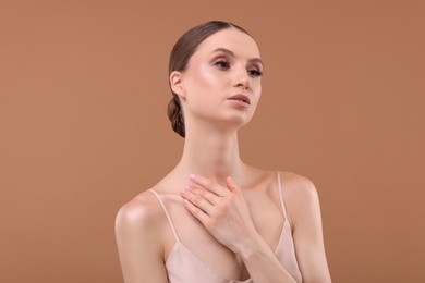 Photo of Portrait of beautiful young woman on beige background